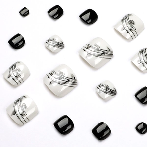 Glossy black and white ink leaf press-on toenails with abstract botanical designs