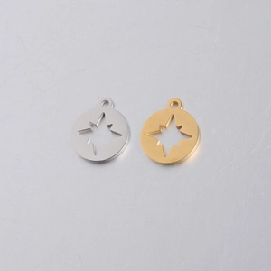 Detailed view of round hollow compass star pendants in silver and gold stainless steel