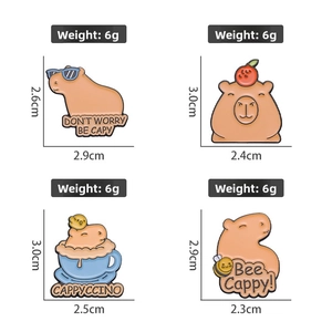 Detail view of four capybara enamel pins with creative puns and cute animal designs