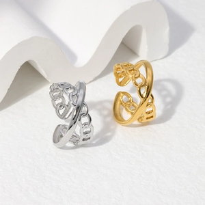 Macro shot of adjustable gold and silver stainless steel rings with layered chain texture