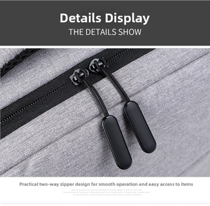 Detail of durable grey fabric backpack showing a heavy-duty black two-way zipper system