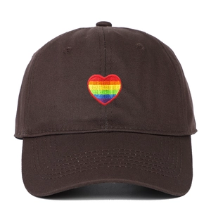 Close-up of rainbow heart embroidery on dark brown cotton twill baseball cap