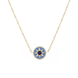 Close-up of golden octagonal star on blue enamel pendant with delicate gold chain