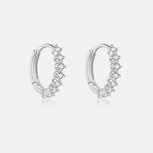 Macro detail of S925 sterling silver hoop earrings with white cubic zirconia pavé setting