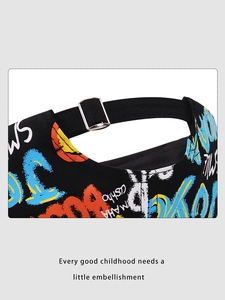 Detail of adjustable silver buckle and colorful graffiti print on black canvas cap