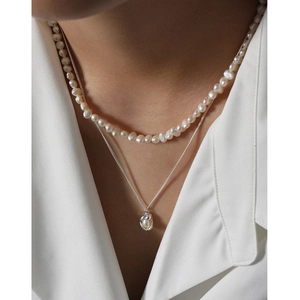 Double-layered S925 silver necklace featuring natural shell pearls on a female model