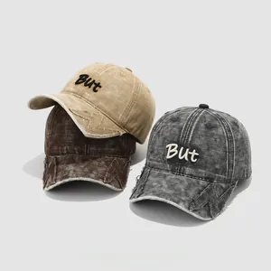 Three distressed cotton kids baseball caps with 'But' embroidery in khaki and brown