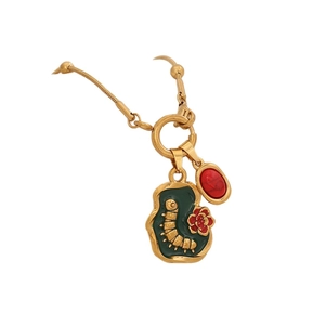 Vintage elephant gold necklace with caterpillar green pendant and red floral detail