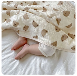 Close-up of soft breathable cotton gauze baby blanket with cute brown bear prints