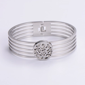 Detail of silver hollowed stainless steel bracelet with central diamond tree ornament