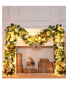 Close-up of 270cm PVC Christmas garland with gold bows, LED lights, and Merry Christmas sign