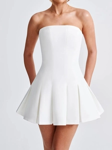 Detailed view of the elegant white strapless mini dress with pleated hem design