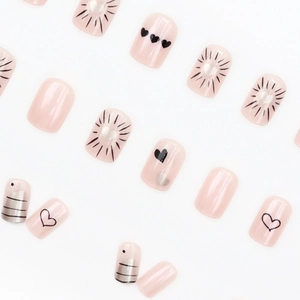 Pink heart press-on nails set with glitter and cute patterns on white background
