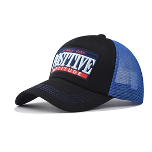 Detail of 3D embroidered Positive Attitude patch on a black and blue mesh trucker hat