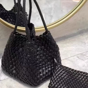 Handwoven black leather bucket bag with matching zipper pouch and long woven shoulder strap