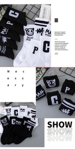 Detail showing street graffiti patterns on black and white cotton athletic crew socks