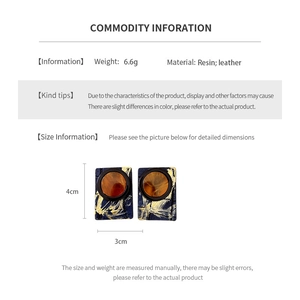 Detailed view of resin and leather square earrings with 4cm height and 3cm width dimensions