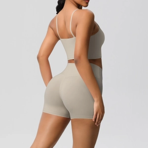 Detail view of seamless light beige yoga set with cross back sports bra and high waist shorts
