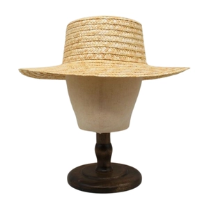 Close-up of fine natural wheat straw weave texture on a flat top boater summer hat