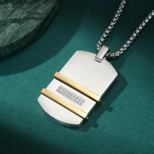 Macro view of men's stainless steel dog tag pendant with golden stripes and pavé zircons