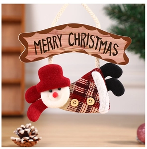 Detail of Christmas snowman pendant with red hat and 'MERRY CHRISTMAS' wooden sign decoration