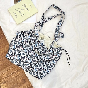 Macro detail of the butterfly print on this lightweight nylon tote bag with drawstring