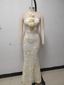 Detail of ivory halter neck dress with 3D floral accents and elegant fishtail silhouette