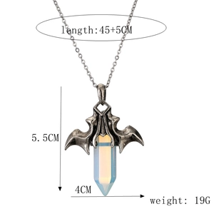 Macro detail of bat wing pendant with opal crystal and size dimensions measurement