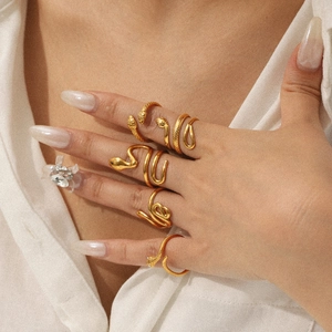 Macro detail of snake-shaped 18K gold stainless steel rings on a female model