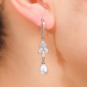 Detail of luxury drop earring with leaf-shaped rhinestones and white pear-shaped pearl