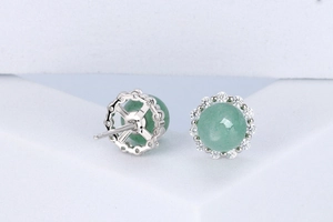 Macro shot of S925 silver stud earrings featuring green aventurine and zircon halo