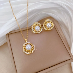 Titanium steel jewelry set with rotating pearl and zircon stones on white silk