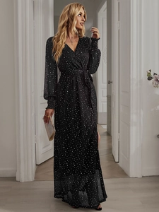 Detail of elegant black long sleeve maxi dress with white polka dots and V-neck wrap design
