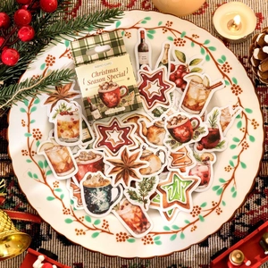 Boîte de stickers sur le thème de Noël avec motifs de cacao et biscuits festifs