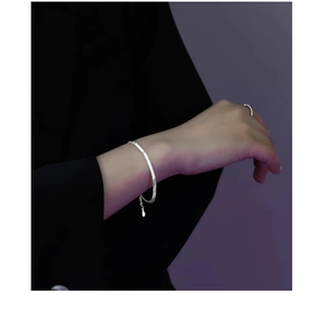 Close-up of minimalist S925 sterling silver flat snake chain bracelet on a wrist
