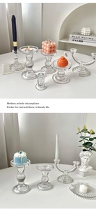 Detailed view of various geometric clear glass candle holders for elegant home decor