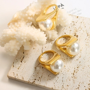 Artistic gold titanium steel ring set with large faux pearls in geometric design
