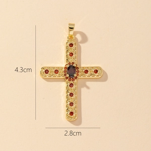 Close-up of gold cross pendant with red crystals showing 4.3cm height and 2.8cm width
