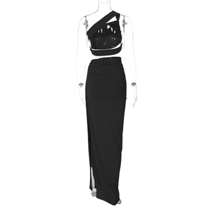Detail of black two-piece set featuring asymmetrical crop top and high-waisted maxi skirt