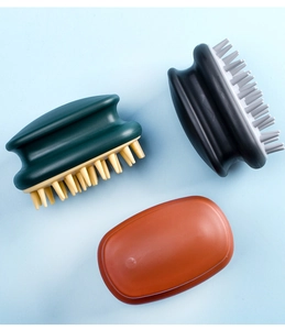 Three silicone scalp massagers in green, black and orange on light blue background