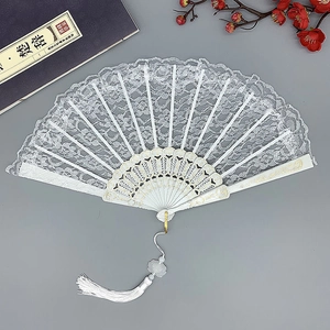 Elegant white lace folding fan with gold-edged ribs and long tassel for dance or photography