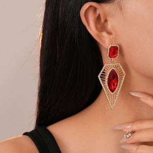 Macro shot of vintage Ancora red gemstone drop earrings with geometric gold settings