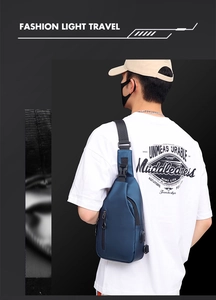 Detail view of stylish blue crossbody bag for men featuring functional hardware and USB port