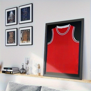 Detail of red sports jersey in a black magnetic display frame for wall decoration