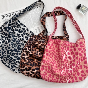 Detailed view of large leopard print canvas tote bags in three colors with magnetic closure