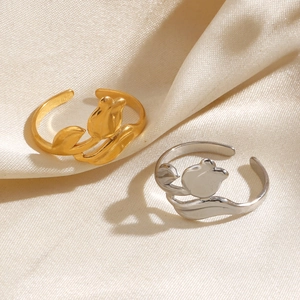 Polished 18K gold and silver plated tulip open rings on elegant beige satin fabric