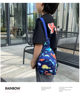 Close-up of kids dinosaur print chest bag with blue waterproof fabric and zipper details