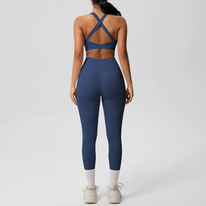 Detail of high-impact yoga set with cross-back sports bra and high-waisted leggings