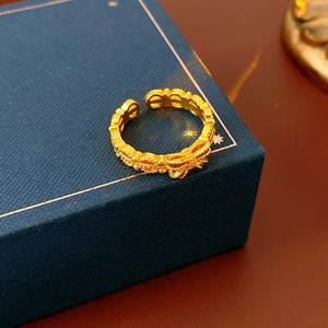 Macro shot of vintage gold lace ring with zircon floral details on blue jewelry box