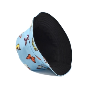 Detail of reversible sun hat showing light blue butterfly print and solid black inner